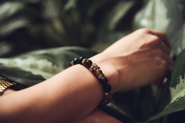 chakra bracelet on persons hand