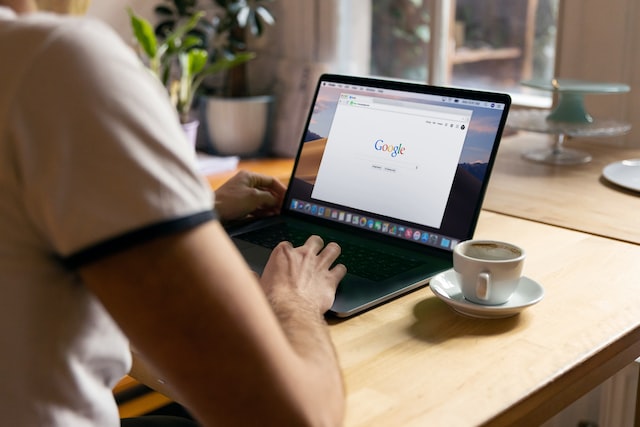 person working on computer with google