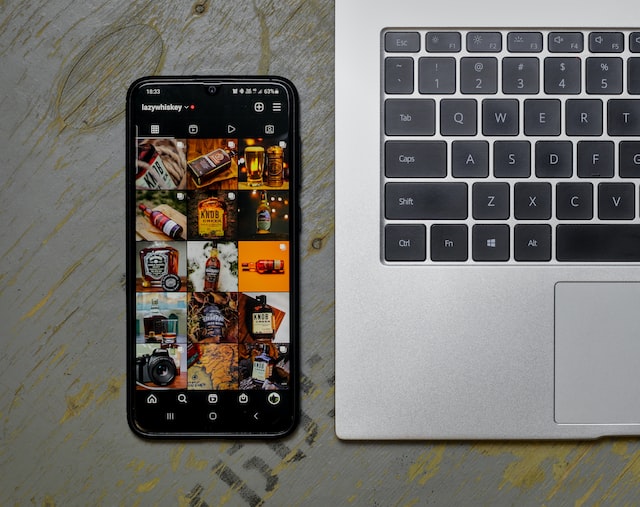 phone near laptop with instagram opened