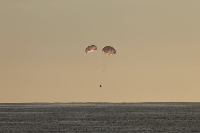 space capsule landing on parachute
