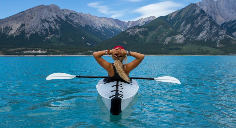 woman riding kayak at the middle of the sea