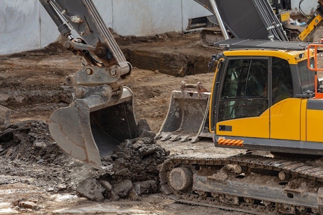 yellow-and-black-excavator-on-brown-soil