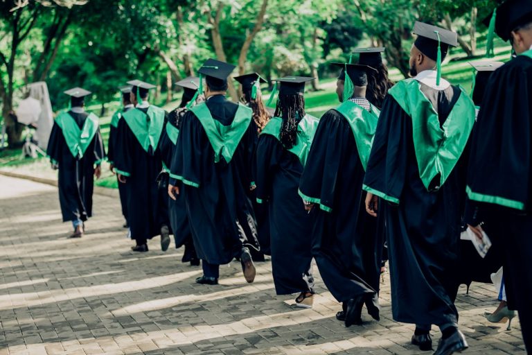 university-graduates-walking-in-outdoor-ceremony