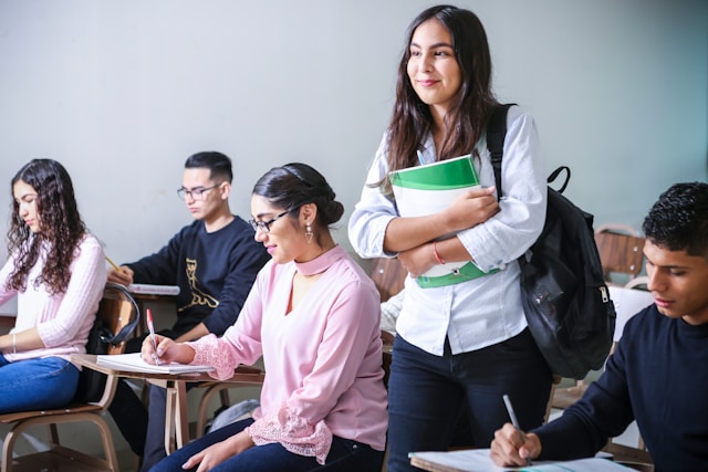 woman-carrying-white-and-green-textbook