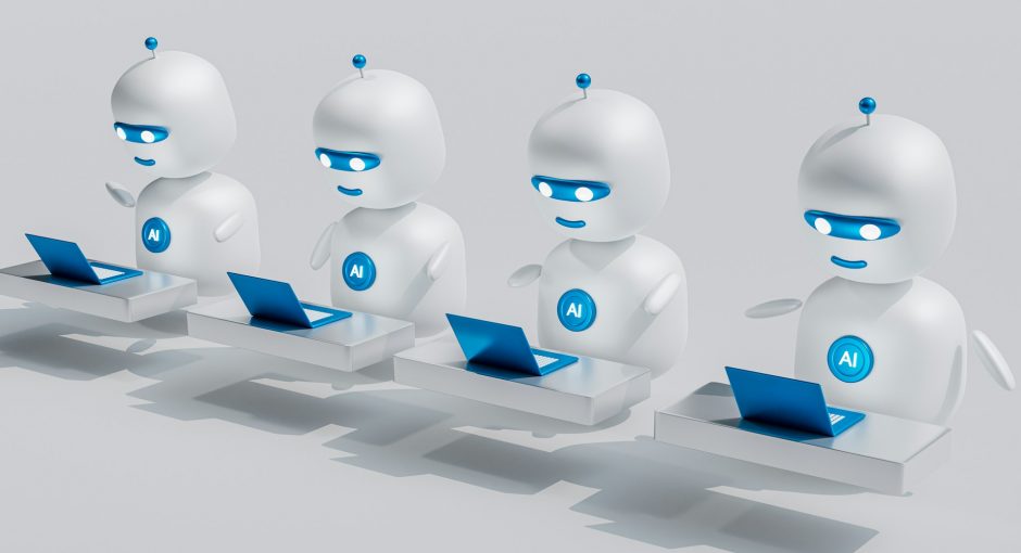 a-group-of-white-robots-sitting-on-top-of-laptops