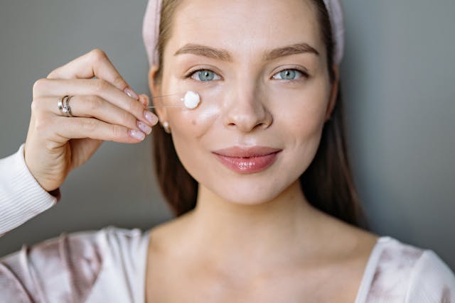 close-up-shot-of-woman-applying-face-cream