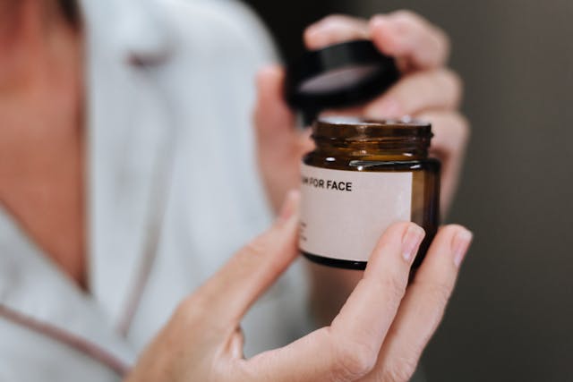 woman-holding-face-cream