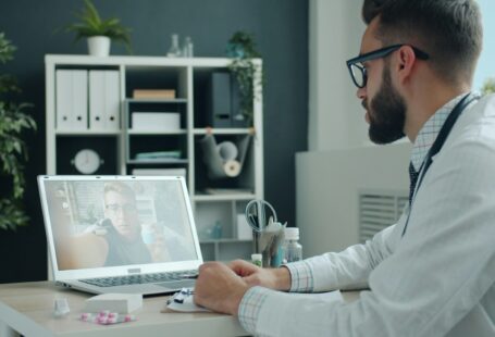 doctor-consulting-patient-via-video-call-on-laptop