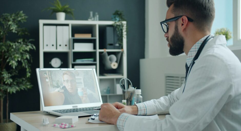 doctor-consulting-patient-via-video-call-on-laptop